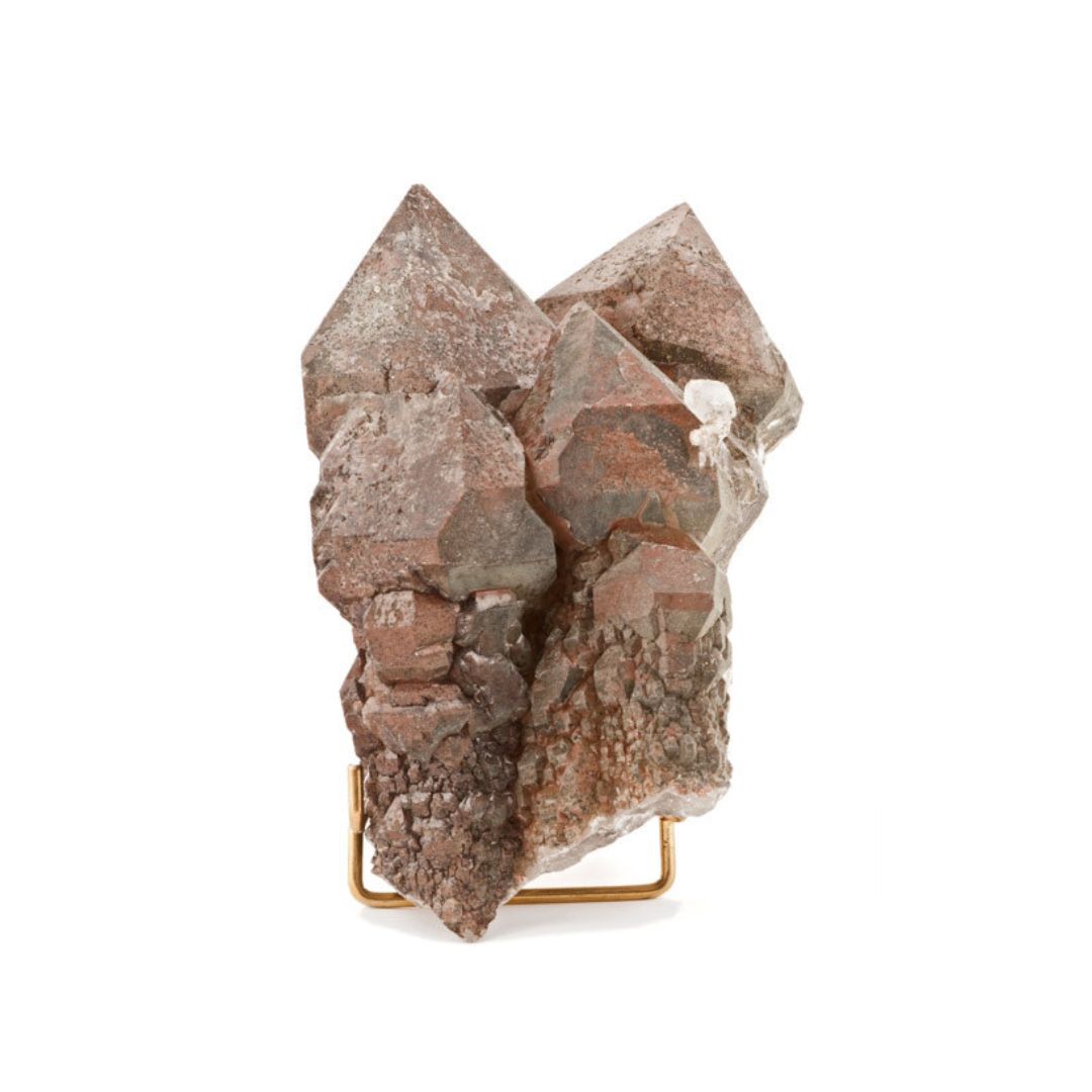 Quartz, a brown/pink rock on a gold stand.