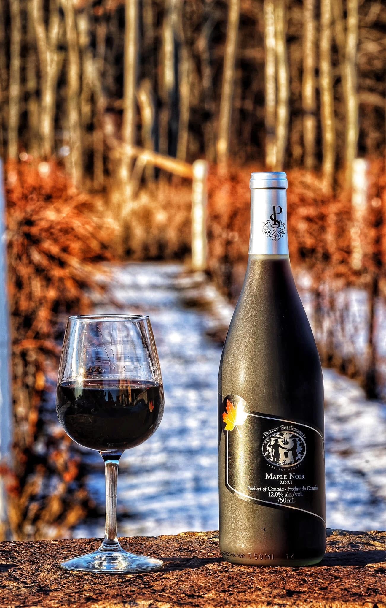Wine sitting on a bar top with a vineyard in the background