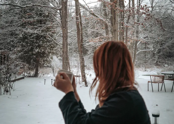 Woman sitting with coffee looking out the window